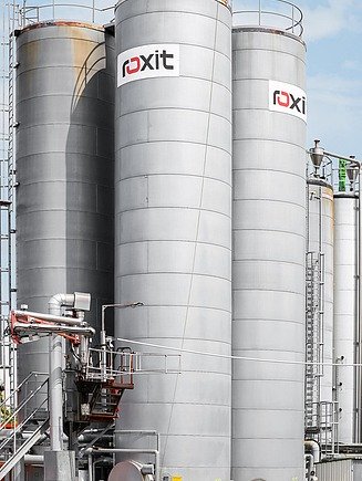 Mehrere große, vertikale Bitumenlagertanks einer Industrieanlage, verbunden durch Rohrleitungen und Steigleitern, als Bestandteil einer umfassenden Bitumen-Komplettlösung.