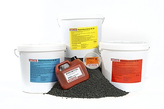 Various bitumen-based products in bucket and canister packaging, including repair mortar, binders and granules, presented as a clearly organised product range for different applications.