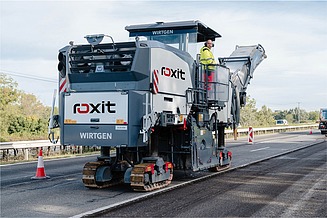 Road milling machine removes the top asphalt layer on a carriageway