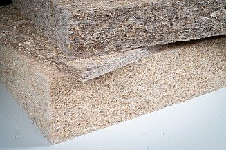 Stacked insulation boards made of fibrous material with visible natural structure and irregular surface in detail.