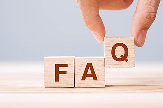 Hand places a wooden block with the letter 