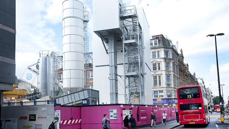 Mobile concrete mixing plant and silos on inner-city construction site of the Crossrail project in London for the production of shotcrete and annular gap mortar